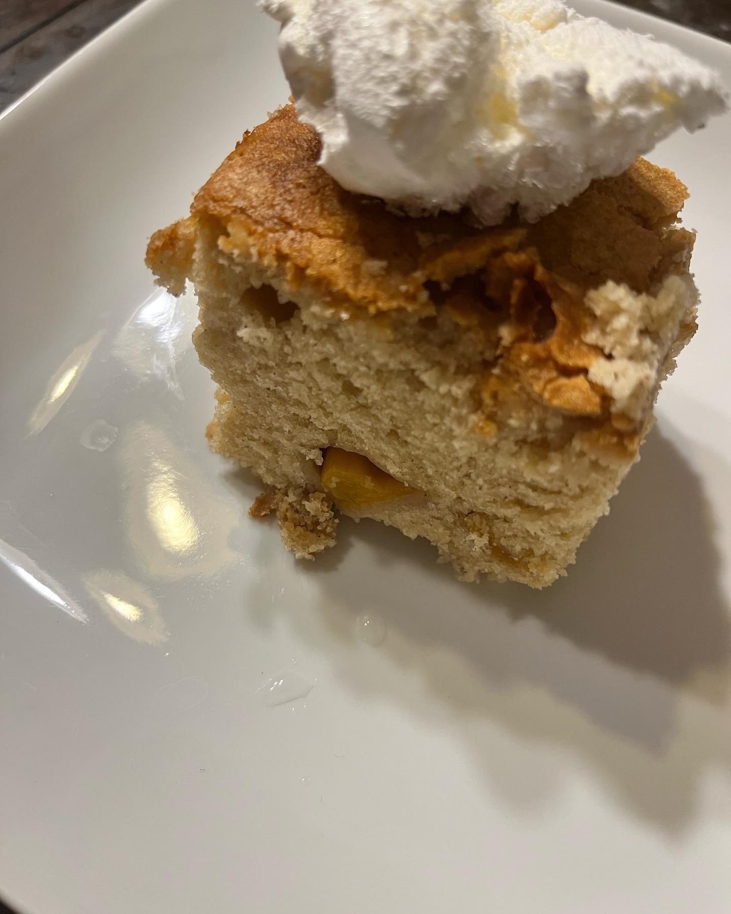 Peach cobbler with whipped cream